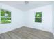 Sun-filled bedroom featuring durable flooring, fresh paint, and windows with green views at 451 Collier Ridge Dr, Atlanta, GA 30318