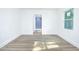 Bright bedroom with white walls, wood floor, and view to modern bathroom at 451 Collier Ridge Dr, Atlanta, GA 30318