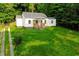 Charming single-Gathering home features a covered porch with a well-maintained lawn and driveway at 451 Collier Ridge Dr, Atlanta, GA 30318