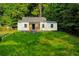 Newly renovated home with fresh exterior paint, a blue front door and a neatly kept lawn at 451 Collier Ridge Dr, Atlanta, GA 30318