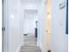 Bright hallway leading to a bathroom, showcasing wood-look flooring and crisp white walls at 451 Collier Ridge Dr, Atlanta, GA 30318