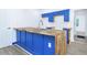 Stylish kitchen with butcher block island, blue cabinets, and stainless steel sink, a chef's dream at 451 Collier Ridge Dr, Atlanta, GA 30318