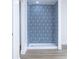 New shower featuring distinctive blue and white tile and a white shower pan at 451 Collier Ridge Dr, Atlanta, GA 30318