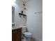 Bathroom with a granite countertop vanity, toilet, and decorative shelf at 6980 Roswell Rd # E11, Atlanta, GA 30328