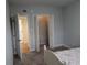 Cozy bedroom featuring an open closet with sliding doors and light blue walls at 6980 Roswell Rd # E11, Atlanta, GA 30328
