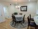 Bright dining area featuring a round table under a chandelier, adjacent to the kitchen at 6980 Roswell Rd # E11, Atlanta, GA 30328