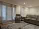 Bright living room with natural light, a leather sofa set, and a decorative rug at 6980 Roswell Rd # E11, Atlanta, GA 30328