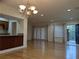 Spacious living room features hardwood floors, a decorative chandelier, and natural light from the windows at 6980 Roswell Rd # E11, Atlanta, GA 30328