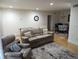 Living room featuring leather sofas, a decorative rug, and hardwood floors at 6980 Roswell Rd # E11, Atlanta, GA 30328