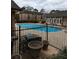Community pool area featuring clear blue water, lounge chairs, and a secure fenced surround at 6980 Roswell Rd # E11, Atlanta, GA 30328