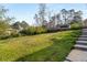 Lawn leading to the back of the house with a few small trees, and steps leading to the house at 2600 Cohassett Ct, Decatur, GA 30034