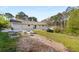 Sloping yard with newly installed raised planting beds off patio and distant house view at 2600 Cohassett Ct, Decatur, GA 30034