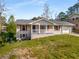 Charming home boasts a brick facade, front porch, manicured lawn, and attached garage at 2600 Cohassett Ct, Decatur, GA 30034