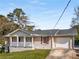 Charming brick home with a covered front porch, shutters, and attached garage at 2600 Cohassett Ct, Decatur, GA 30034