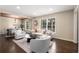 Sun-drenched living room with hardwood floors, neutral decor, and an open layout to the dining area at 2600 Cohassett Ct, Decatur, GA 30034