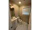 Bathroom with a built-in toilet, vanity with sink, and large mirror at 650 Moseley Rd, Stockbridge, GA 30281