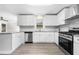 Well-lit kitchen with new appliances, granite counters, and shaker cabinets, seamlessly flows into the living space at 147 Hermer Nw Cir, Atlanta, GA 30311