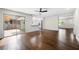Open-concept living area with hardwood floors, sliding glass doors, and a view into the modern kitchen at 147 Hermer Nw Cir, Atlanta, GA 30311