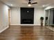 Spacious living room with hardwood floors, a modern fireplace feature, and ample natural light from sliding glass doors at 147 Hermer Nw Cir, Atlanta, GA 30311