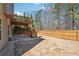 Spacious backyard with a wooden fence and second story deck with stairs at 1595 Johnstown Trace, Suwanee, GA 30024