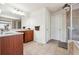 Bathroom with tile floors, double vanity, and a walk in shower with glass door at 1595 Johnstown Trace, Suwanee, GA 30024