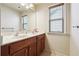 Well lit bathroom featuring a double vanity and framed mirror at 1595 Johnstown Trace, Suwanee, GA 30024