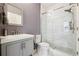 Modern bathroom featuring a glass shower, gray vanity, and tiled floor at 1595 Johnstown Trace, Suwanee, GA 30024