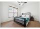 Bright bedroom with a large window and a black bed frame at 1595 Johnstown Trace, Suwanee, GA 30024