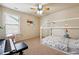 Cozy bedroom with a unique bed frame, ceiling fan, and a piano at 1595 Johnstown Trace, Suwanee, GA 30024