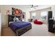 Bedroom featuring a wooden bed frame, neutral walls and carpet, and two windows at 1595 Johnstown Trace, Suwanee, GA 30024