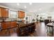 Open kitchen featuring a center island with seating and stainless steel appliances at 1595 Johnstown Trace, Suwanee, GA 30024