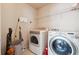Laundry room featuring a washer and dryer with wire shelving above at 1595 Johnstown Trace, Suwanee, GA 30024