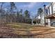 Large backyard with covered patio extending from the rear of the home into the yard at 310 Persimmon Dr, Sharpsburg, GA 30277
