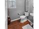 This bathroom features wood look floors, a comfort height toilet, and a pedestal sink at 310 Persimmon Dr, Sharpsburg, GA 30277