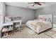 A bright bedroom with a study area is decorated with soft colors at 310 Persimmon Dr, Sharpsburg, GA 30277