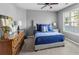 Bedroom with carpet, large window, blue bedding and hardwood furniture at 310 Persimmon Dr, Sharpsburg, GA 30277