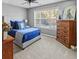 Bedroom with large window, carpet, blue bedding and hardwood furniture at 310 Persimmon Dr, Sharpsburg, GA 30277