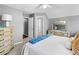 A relaxing bedroom with gray walls, and cream colored dressers, topped with a light blue bed throw at 310 Persimmon Dr, Sharpsburg, GA 30277