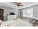 Bright bedroom featuring a ceiling fan, window, and neutral decor at 310 Persimmon Dr, Sharpsburg, GA 30277