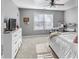 Cozy bedroom with a white dresser, ceiling fan, and large window at 310 Persimmon Dr, Sharpsburg, GA 30277