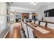 Dining room featuring a large table and chairs; open to the kitchen and living room at 310 Persimmon Dr, Sharpsburg, GA 30277