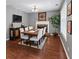 Dining room featuring modern chairs, hardwood floors, and a fireplace at 310 Persimmon Dr, Sharpsburg, GA 30277