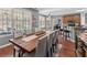 Dining room with a long table and chairs, hardwood floors, and many windows at 310 Persimmon Dr, Sharpsburg, GA 30277