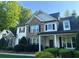 Beautiful two-story home with stone accents, black shutters and a welcoming front porch at 310 Persimmon Dr, Sharpsburg, GA 30277