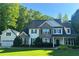 Charming two-story home featuring a stone and siding facade, manicured lawn, and an attached two car garage at 310 Persimmon Dr, Sharpsburg, GA 30277