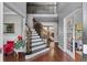 Grand two-story foyer with hardwood floors, staircase and views into the living spaces at 310 Persimmon Dr, Sharpsburg, GA 30277