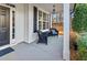 Inviting covered front porch with comfortable wicker seating and a view of the manicured front yard at 310 Persimmon Dr, Sharpsburg, GA 30277