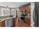 Eat-in kitchen features wood cabinets, stainless appliances, and granite countertops at 310 Persimmon Dr, Sharpsburg, GA 30277