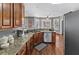 The kitchen features hardwood floors, stainless appliances, granite countertops, and a kitchen nook at 310 Persimmon Dr, Sharpsburg, GA 30277