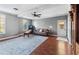 Spacious living room featuring hardwood floors, a comfortable leather sofa, and abundant natural light at 310 Persimmon Dr, Sharpsburg, GA 30277
